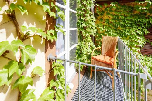 a chair sitting on a balcony next to a window at Zum Roten Bären in Freiburg im Breisgau