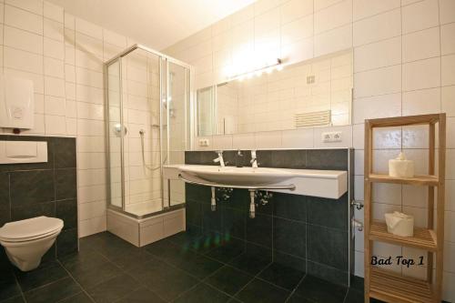 a bathroom with a sink and a toilet and a mirror at Almliesl ZELL-232 in Zell am See