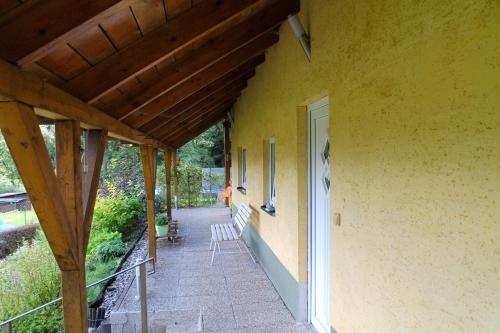a porch of a house with two chairs on it at Apartmány pod Ještědem in Liberec