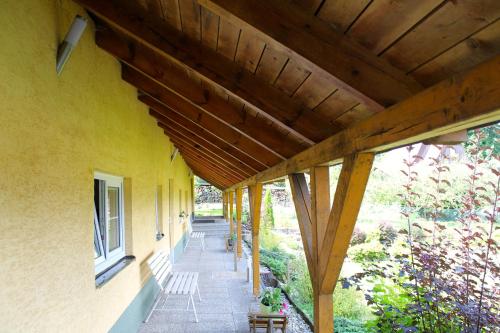 a porch of a house with a wooden roof at Apartmány pod Ještědem in Liberec