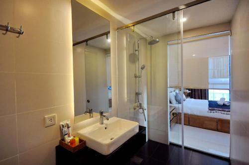 a bathroom with a sink and a shower at Holi Beach Hotel & Apartments in Nha Trang