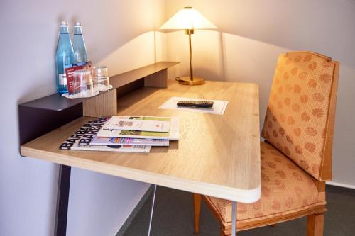 a desk with a chair and a lamp on it at Zum Roten Bären in Freiburg im Breisgau