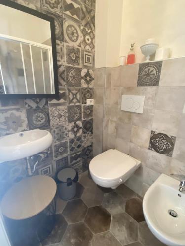 a bathroom with a toilet and a sink at Christy House in Vignale
