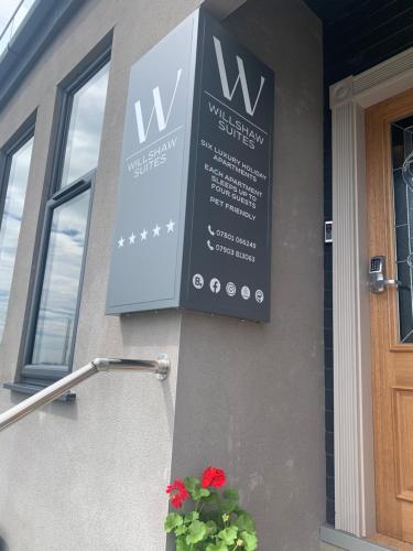 a sign on the side of a building at Willshaw Suites for families over 25 only in Blackpool