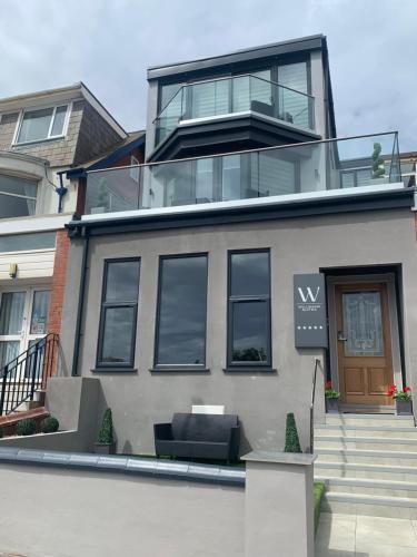 a large house with a balcony on top of it at Willshaw Suites for families over 25 only in Blackpool