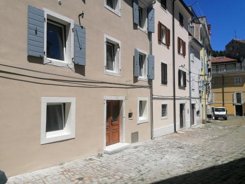 a building with a door on a street at GG art apartments II in Piran