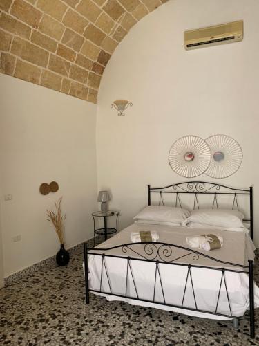 a bedroom with a bed and a brick wall at Nonna Veronica in Gemini