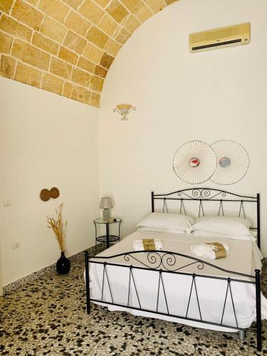 a bedroom with a bed and a brick wall at Nonna Veronica in Gemini