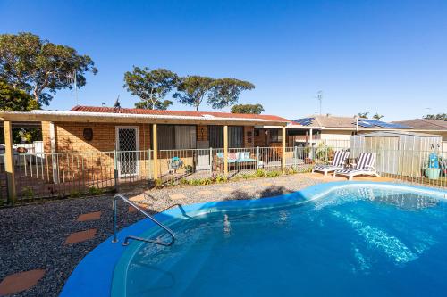 a swimming pool in front of a house at Flora Parade 6 in Tuncurry