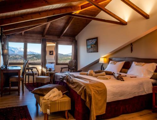 1 dormitorio con 1 cama grande en una habitación con escritorio en Hotel Rodovoli en Konitsa
