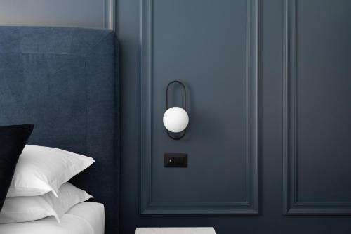 a bedroom with a door with a white light on it at DA ME Suites in Rome
