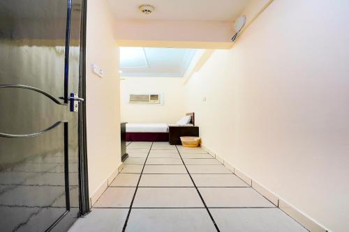 a hallway leading to a room with a bed at OYO 124 Al Salam Palace Hotel in Manama