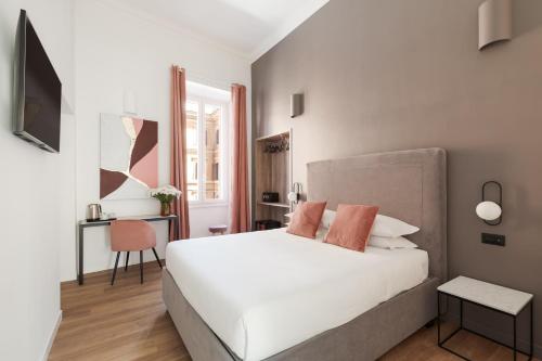 a bedroom with a white bed and a desk at DA ME Suites in Rome