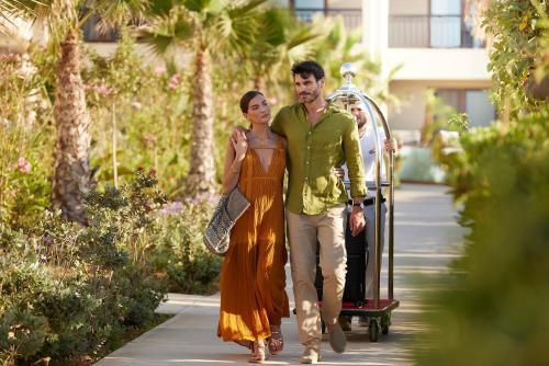 a man and a woman walking down a sidewalk at Asterion Suites & Spa - Designed for Adults in Gerani Chanion