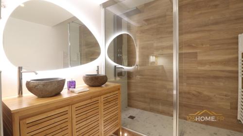 a bathroom with two sinks and a shower at 123home- Garden & Spa in Serris