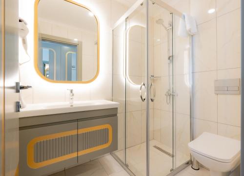 a bathroom with a shower and a sink and a toilet at Gurses Life Hotel in Alanya