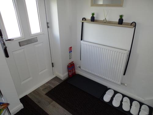a room with a white door and a black rug at Stony Apartment House in Doncaster