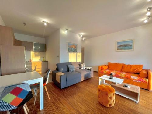 a living room with a couch and a table at Seaview Couple Studio with pool-Przno in Pržno