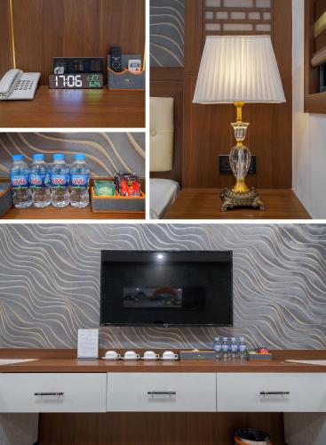 a room with a tv and a lamp on a desk at Sunland Halong Hotel and Restaurant in Ha Long