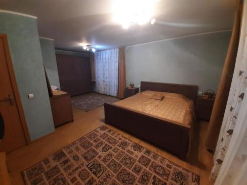 a bedroom with a bed in a room with a rug at 2Rivers in Săsciori