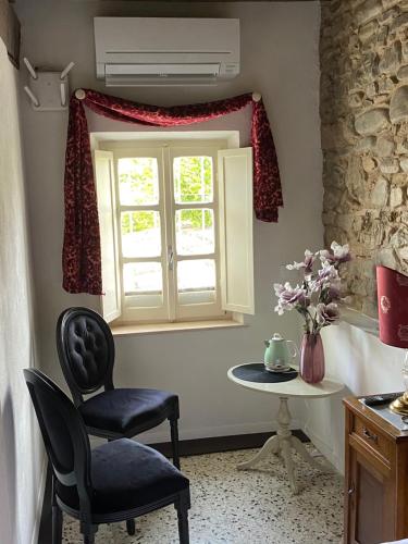 a room with a chair and a table and a window at Christy House in Vignale