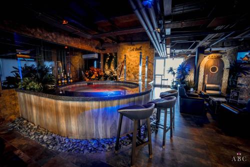 a bar with a tub in the middle of a room at ABC Entertainment Resort in Angeles