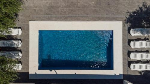 an aerial view of a pool of water next to parked cars at Villa de lujo EL MIRADOR in L'Ampolla