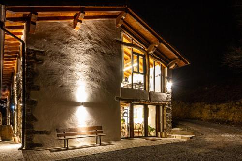 a building with a bench in front of it at night at Mokorroko Borda Hostal Rural in Echalecu