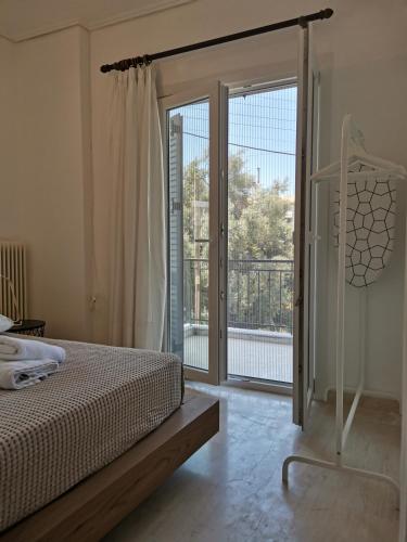 a bedroom with a bed and a sliding glass door at Sti Chora Apartments in Lefkada Town