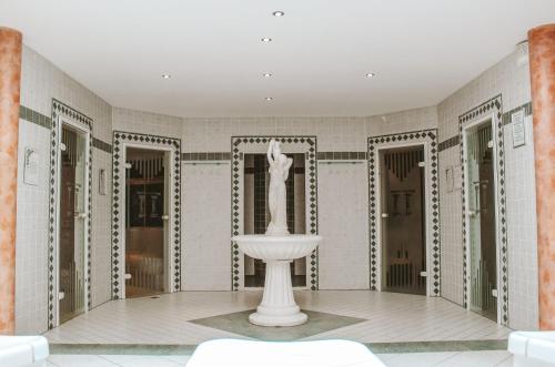 a white room with a fountain in the middle of it at Kaiserhof in Reit im Winkl