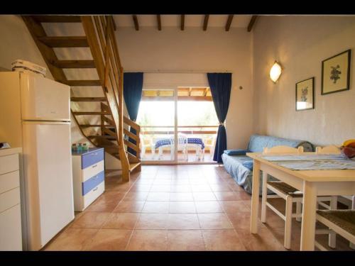 Il dispose d'une cuisine et d'un salon avec une table et un réfrigérateur. dans l'établissement Marina Corsa Res 4 rooms apartment 2 bathrooms 150 m from the sea Ghisonaccia, à Ghisonaccia