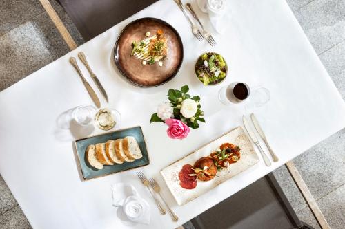 a white table with plates of food on it at Seminarhotel Lengbachhof GmbH in Altlengbach