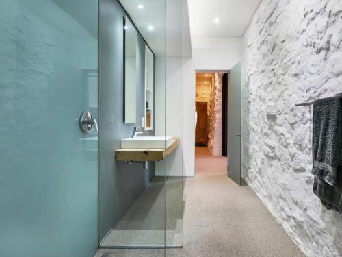 a bathroom with a sink and a mirror at Behr Road Apartment with sea view patio in Cape Town