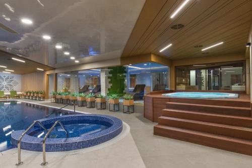 a hotel lobby with a hot tub and a spa at Wine & SPA Hotel Chukara in Tryavna