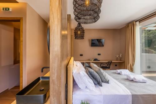 a bedroom with a large bed and a sink at AGNONTAS LUXURY VILLAS in Agnontas