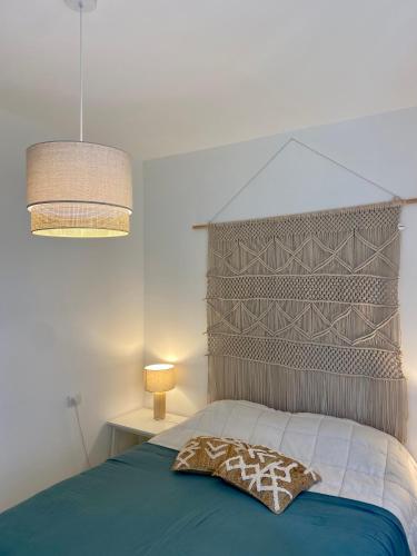 a bedroom with a bed with a large headboard at La Casa di Greta in Celle Ligure