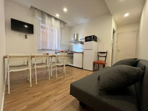 a kitchen and living room with a table and chairs at Casa Vacanze Caramagna 2 in Aci Castello