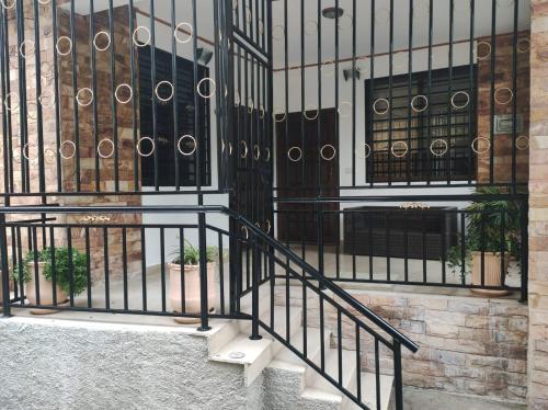 a building with a wrought iron gate and stairs at Holiday home On The rocks in Murree
