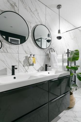a bathroom with a sink and two mirrors at The LUXE - Premium Georgian Central Plymouth House - Sleeps 8 - Habita Property in Plymouth