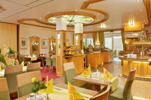 a restaurant with tables and chairs in a room at Park Hotel Laim Serviced Apartments in Munich