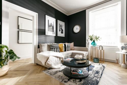 a living room with a couch and a table at The LUXE - Premium Georgian Central Plymouth House - Sleeps 8 - Habita Property in Plymouth