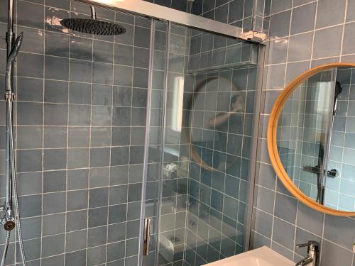 een blauw betegelde badkamer met een spiegel en een wastafel bij Be-Cool Salou pool center in Salou