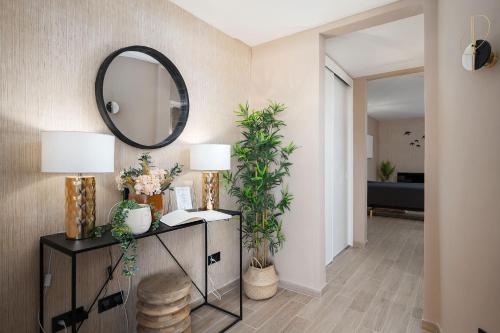 un couloir avec un miroir et une table avec des plantes dans l'établissement Kikiana House, à Albufeira