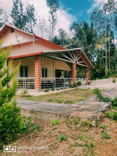 a small house with a red roof at Immanamane Homestay in Chikmagalūr