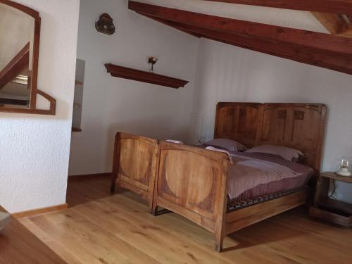 a bedroom with a wooden bed in a room at Casa Mali in Cres