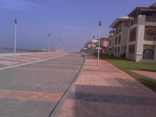 an empty street with street lights and a building at Bahia Golf Beach Bouznika appart in Bouznika