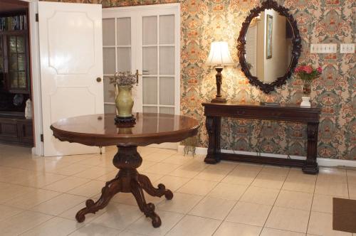 a table with a vase on it in a room at Polkerris Bed & Breakfast in Montego Bay