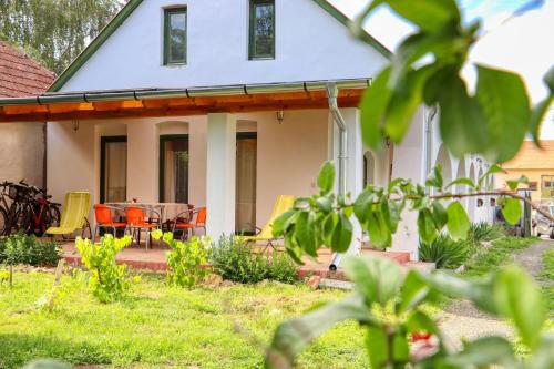 a white house with a table and chairs at Fűszeres Porta in Mihályfa