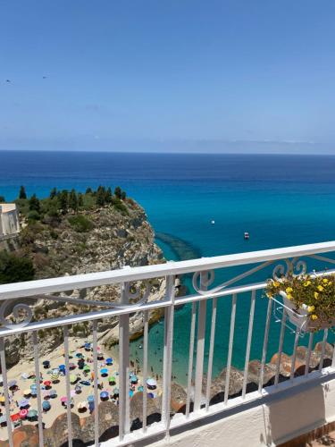 a balcony with a view of a beach and the ocean at BlueMind in Tropea