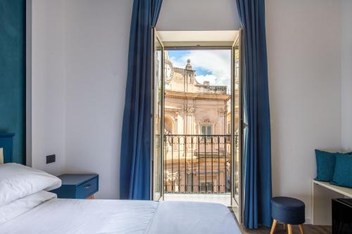 sypialnia z łóżkiem i widokiem na budynek w obiekcie Villena Plaza w mieście Palermo